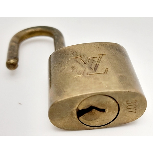 1055 - A Louis Vuitton Small Travel Padlock and Two Keys. 3.5cm.