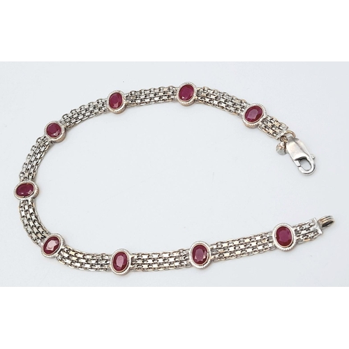 1134 - A 18K WHITE GOLD RUBY SET BRACELET. 5.1G IN WEIGHT. Ref: SC 5078.