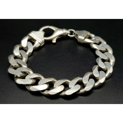 653 - A Chunky Stylish Solid Silver 925 Curb Chain Bracelet, 64.5 grams, 21.5cm. Signs of wear but In very... 