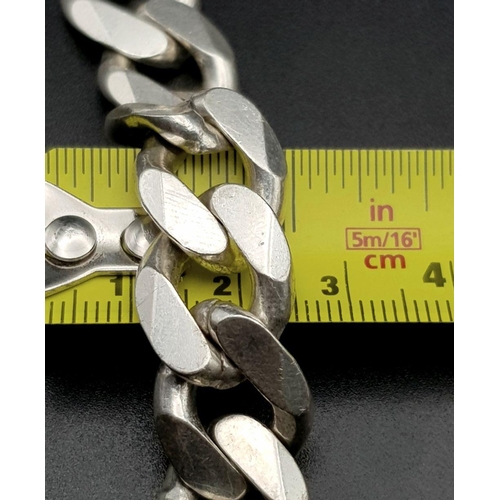 653 - A Chunky Stylish Solid Silver 925 Curb Chain Bracelet, 64.5 grams, 21.5cm. Signs of wear but In very... 