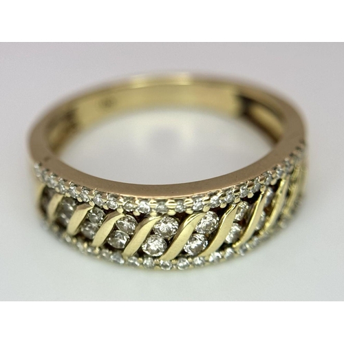 677 - A 9K YELLOW GOLD DIAMOND BAND RING. 0.30CT. 3.2G IN WEIGHT. SIZE O. Ref: SC 5004.