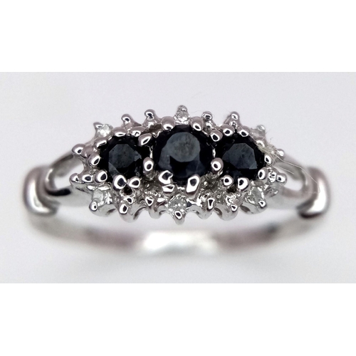 699 - A 9K WHITE GOLD DIAMOND & SAPPHIRE RING - 1.4G. SIZE M. REF: SPAS 5011