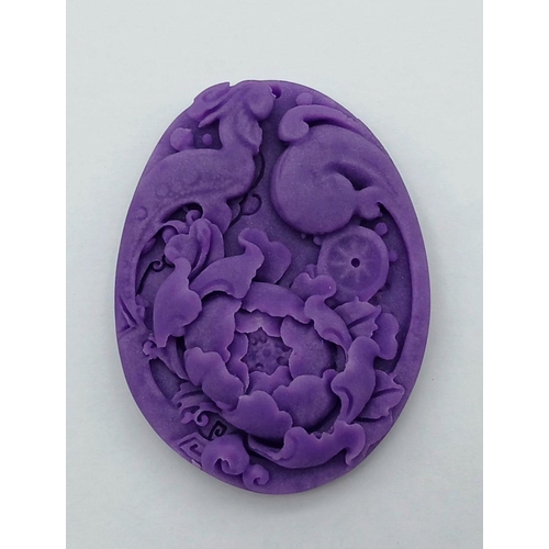 750 - A Chinese Lavender Jade Decorative Floral Oval Pendant. 6cm.