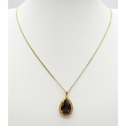 891 - A very elegant 9K yellow gold chain necklace with a pendant carrying a large pear cut smoky quartz s... 