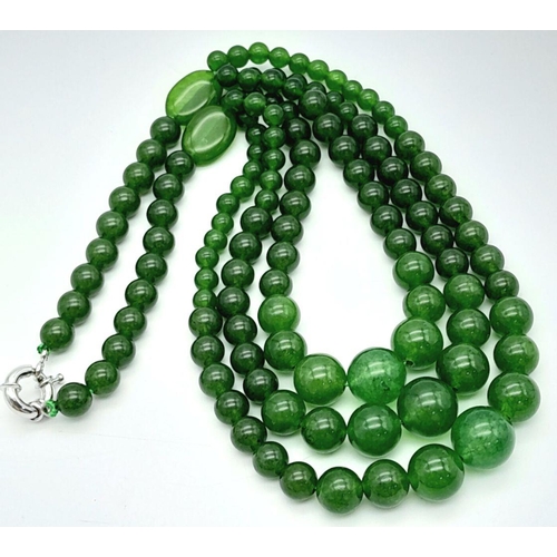 975 - A Chinese Three Row Graduating Green Jade Bead Necklace. Largest beads -14mm. 44-46cm