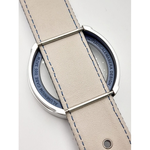 1016 - A Verticale Mechanical Top Winder Gents Watch. Blue textile strap. Ceramic silver tone skeleton case... 