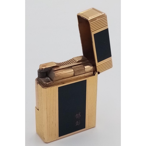 1020 - An S.T. Dupont Gold Plated and Black Enamel Lighter. Needs gas and flint. UK MAINLAND SALES ONLY