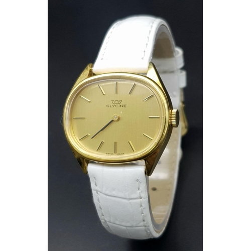 1017 - A Stylish Glycine Mechanical Ladies Watch. White leather strap. Oval gilded case - 31mm. Gilded dial... 