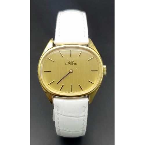 1017 - A Stylish Glycine Mechanical Ladies Watch. White leather strap. Oval gilded case - 31mm. Gilded dial... 