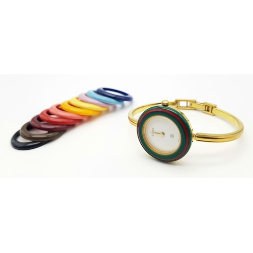 1006 - A Gucci Rainbow Bezel Multi-Change Quartz Ladies Watch. Comes with original warranty. Needs a batter... 