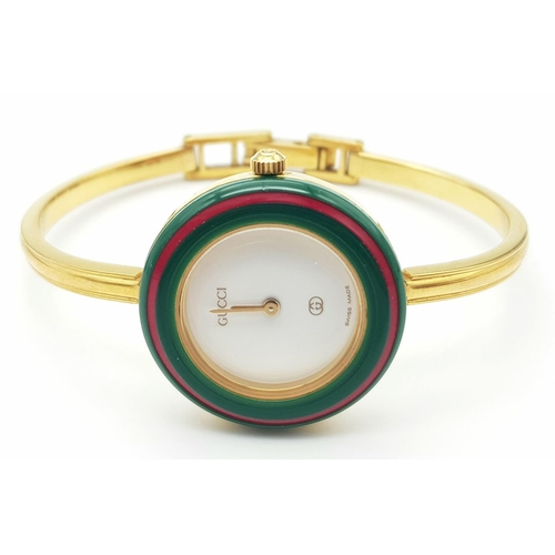 1006 - A Gucci Rainbow Bezel Multi-Change Quartz Ladies Watch. Comes with original warranty. Needs a batter... 