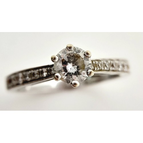 758 - An 18K White Gold Diamond Ring. Central 0.50ct brilliant round cut diamond with diamond accents on w... 