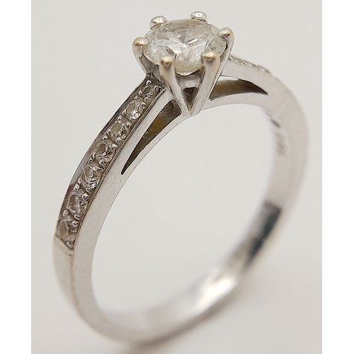 758 - An 18K White Gold Diamond Ring. Central 0.50ct brilliant round cut diamond with diamond accents on w... 