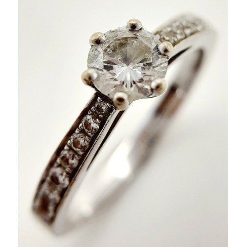 758 - An 18K White Gold Diamond Ring. Central 0.50ct brilliant round cut diamond with diamond accents on w... 