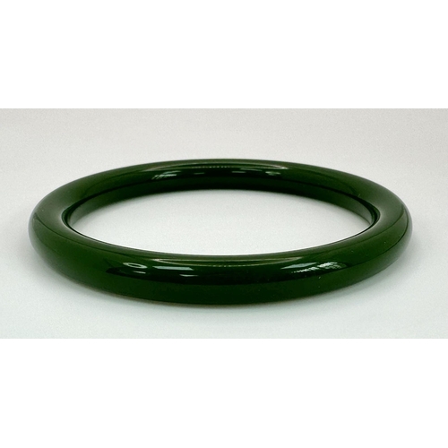 1195 - A Classic Slimline Chinese Green Jade Bangle. 7mm width. 60mm inner diameter.