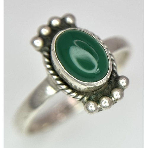 1104 - Four sterling silver items: one green jade ring size: K1/2, one ring with a green stone size: P, a m... 