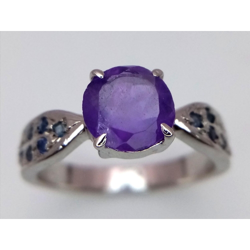 584 - A Round Cut Amethyst Ring with Sapphires on Shoulders. 925 Silver. Size P/Q, 4g total weight. Comes ... 