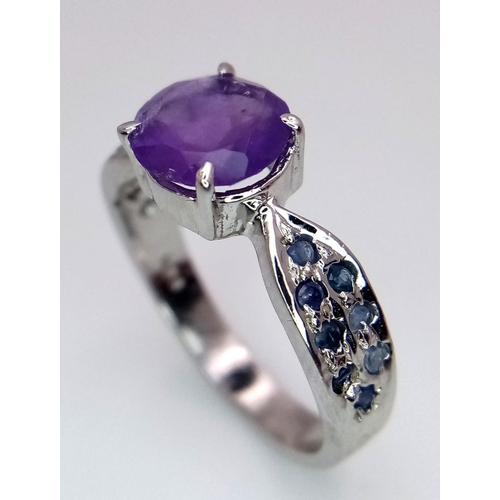 584 - A Round Cut Amethyst Ring with Sapphires on Shoulders. 925 Silver. Size P/Q, 4g total weight. Comes ... 