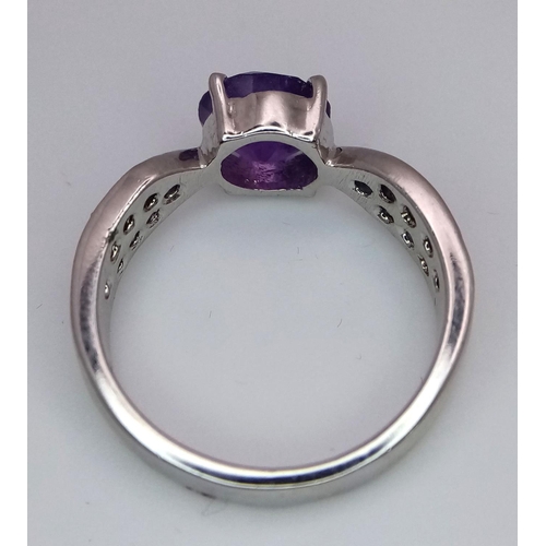 584 - A Round Cut Amethyst Ring with Sapphires on Shoulders. 925 Silver. Size P/Q, 4g total weight. Comes ... 