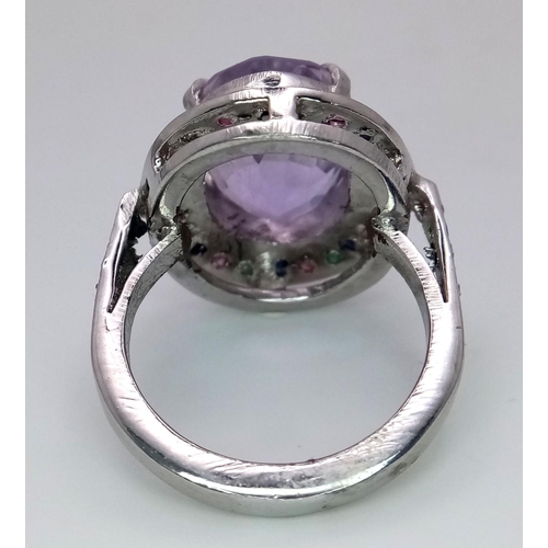 747 - An Amethyst Ring with Multi-Coloured Sapphire Surround. 925 silver. Ring size Q/R, 10g total weight.... 