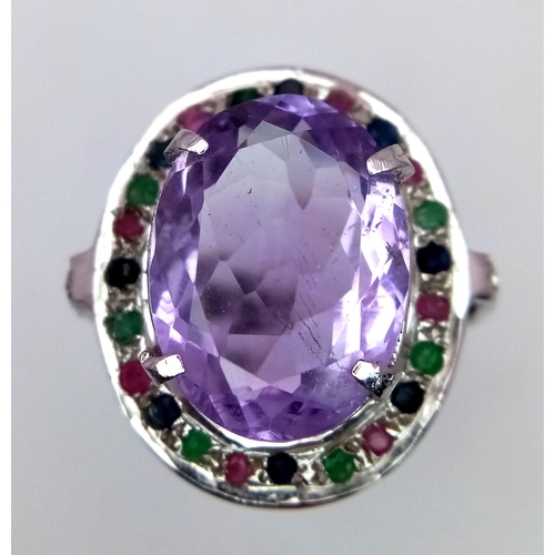 747 - An Amethyst Ring with Multi-Coloured Sapphire Surround. 925 silver. Ring size Q/R, 10g total weight.... 