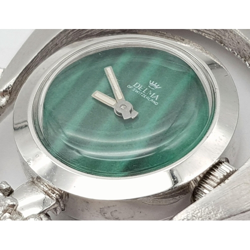 817 - A Delma of Switzerland Pendant Watch on a White Metal Chain. In working order.