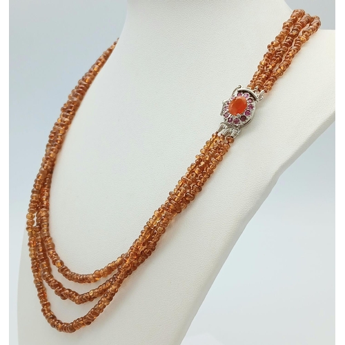 866 - A Hessonite Garnet Three Row Beaded Necklace with Rubies on 925 Silver Clasp. 230ctw. 49cm length, 4... 