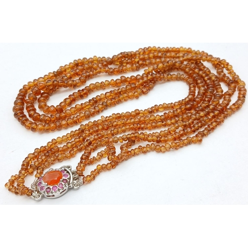 866 - A Hessonite Garnet Three Row Beaded Necklace with Rubies on 925 Silver Clasp. 230ctw. 49cm length, 4... 