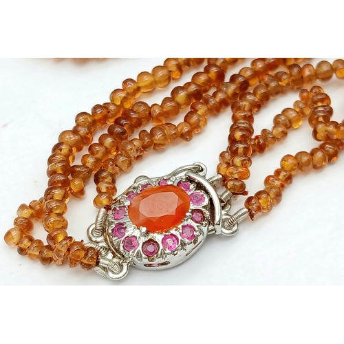 866 - A Hessonite Garnet Three Row Beaded Necklace with Rubies on 925 Silver Clasp. 230ctw. 49cm length, 4... 