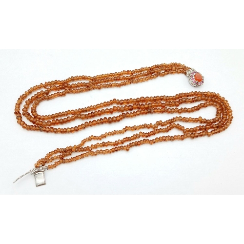 866 - A Hessonite Garnet Three Row Beaded Necklace with Rubies on 925 Silver Clasp. 230ctw. 49cm length, 4... 