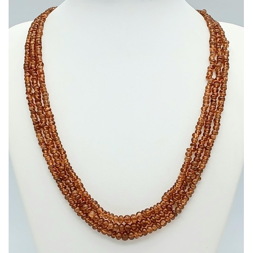 866 - A Hessonite Garnet Three Row Beaded Necklace with Rubies on 925 Silver Clasp. 230ctw. 49cm length, 4... 