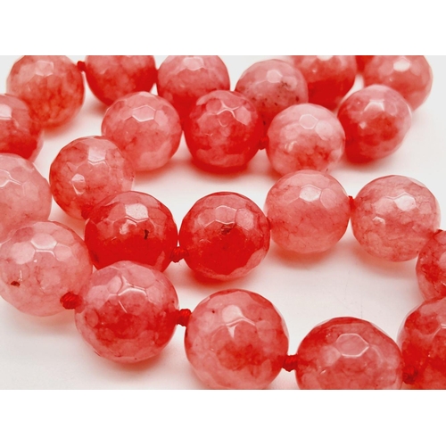 828 - A Faceted Pink/Red Jade Beaded Necklace. 14mm beads. 42cm necklace length.