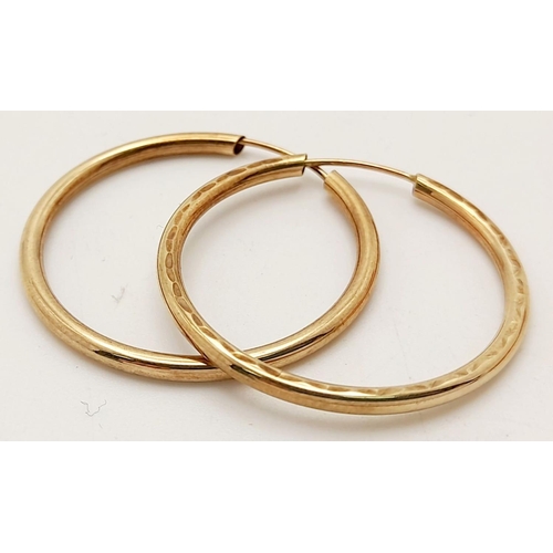 703 - A Pair of 9K Yellow Gold Hoop Earrings. 1.2g