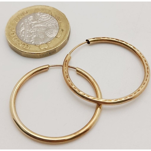 703 - A Pair of 9K Yellow Gold Hoop Earrings. 1.2g