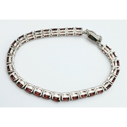 562 - An Almandine Garnet Tennis Bracelet on 925 Silver. 32ctw. 19cm length, 21g total weight. Comes in pr... 