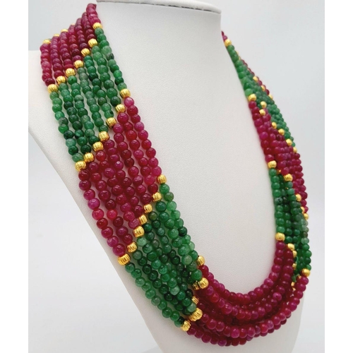 126 - A statement, seven strand multi gem necklace with gilded spacer beads and clasp. Necklace length: 56... 