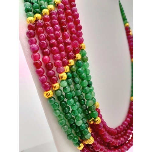 126 - A statement, seven strand multi gem necklace with gilded spacer beads and clasp. Necklace length: 56... 