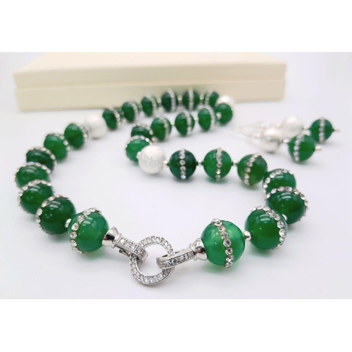 133 - A very elegant, sophisticated and uniquely created, green jade necklace and earrings set, adorned wi... 