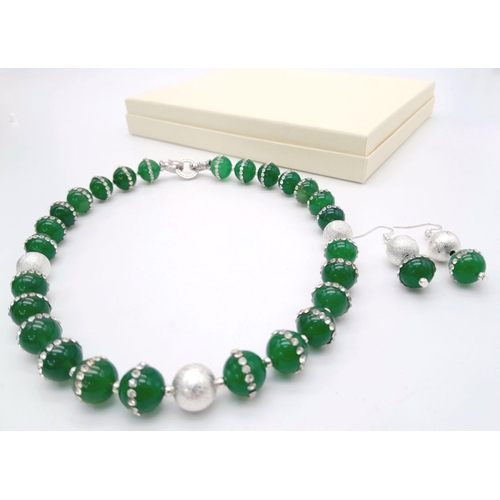 133 - A very elegant, sophisticated and uniquely created, green jade necklace and earrings set, adorned wi... 