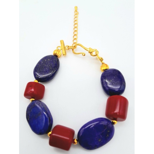 224 - A substantial and very attractive necklace, bracelet and earring set with large oval shaped lapis la... 