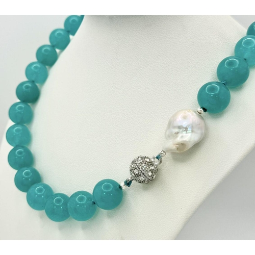 256 - An Ice Blue Topaz Large Beaded Necklace with a Baroque Pearl Interrupter. 14mm beads. 46cm necklace ... 