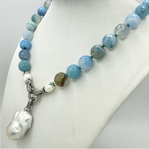 296 - A Wonderful Blue Striped Agate Necklace with Hanging Baroque Pearl Pendant. 12mm beads. 5cm hanging ... 