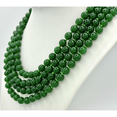 338 - A Classic Four-Row Chinese Dark Green Jade Bead Necklace. 8mm beads. 42-46cm necklace length.