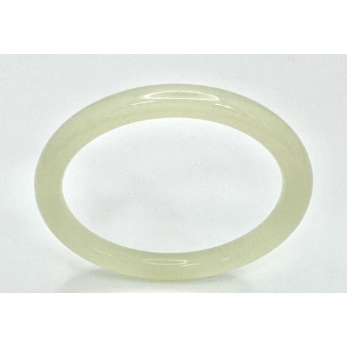 480 - A Classic Thin Pale-Green Jade Chinese Bangle. 8mm width. 60mm inner diameter.