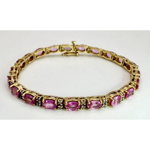 50 - A 14K Yellow Gold, Pink Sapphire and Diamond Tennis Bracelet. Oval cut sapphires with twin diamond s... 