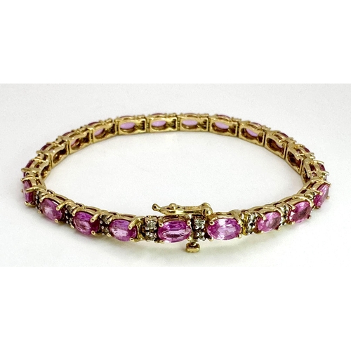 50 - A 14K Yellow Gold, Pink Sapphire and Diamond Tennis Bracelet. Oval cut sapphires with twin diamond s... 