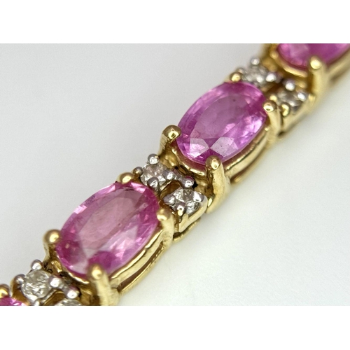 50 - A 14K Yellow Gold, Pink Sapphire and Diamond Tennis Bracelet. Oval cut sapphires with twin diamond s... 