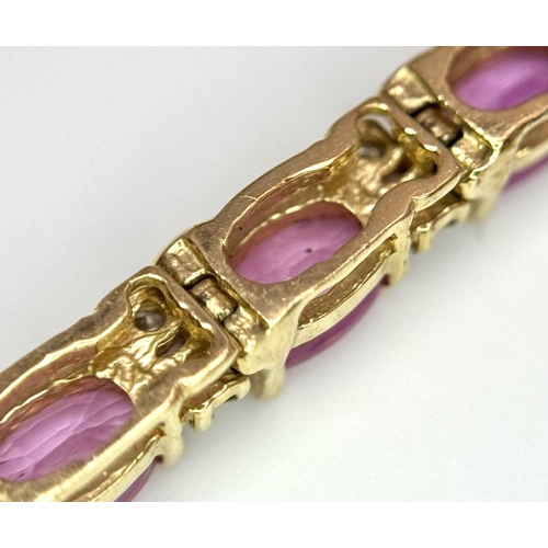 50 - A 14K Yellow Gold, Pink Sapphire and Diamond Tennis Bracelet. Oval cut sapphires with twin diamond s... 