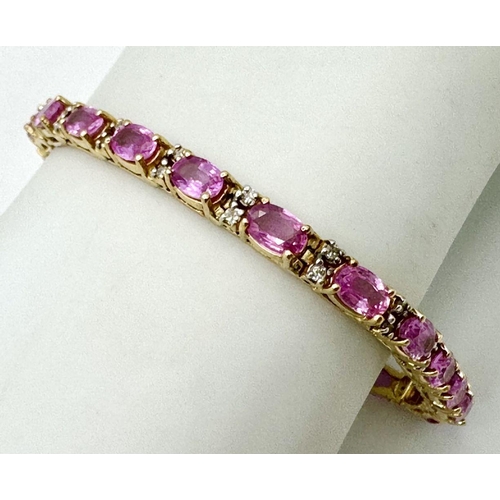 50 - A 14K Yellow Gold, Pink Sapphire and Diamond Tennis Bracelet. Oval cut sapphires with twin diamond s... 