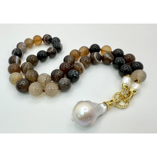 589 - A Striped Earth-Toned Agate Necklace with Hanging Baroque Pendant. 12mm beads. 6cm pendant length. G... 